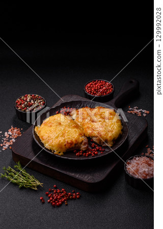 Steak, a pork or chicken chop covered with melted cheese. Grilled meat Steak, a pork or chicken chop covered with melted cheese. Grilled meat 129992028