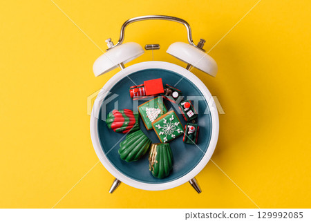 Christmas, gingerbread or madeleine on a plate on a vintage clock. Christmas conceptual background Christmas, gingerbread or madeleine on a plate on a vintage clock. Christmas conceptual background 129992085