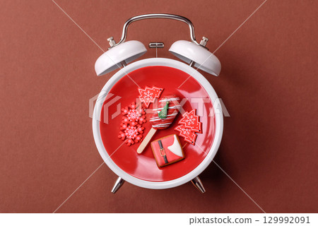 Christmas, eclair on a plate on a vintage clock. Christmas time conceptual background 129992091