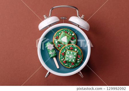 Christmas, eclair on a plate on a vintage clock. Christmas time conceptual background 129992092