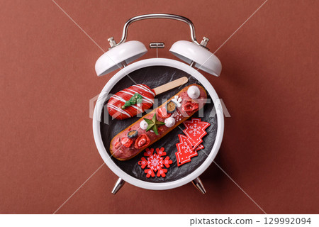 Christmas, eclair on a plate on a vintage clock. Christmas time conceptual background 129992094