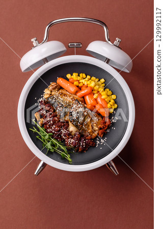 Grilled mackerel fish with peppers and spices. Concept time to eat fish Grilled mackerel fish with peppers and spices. Concept time to eat fish 129992117