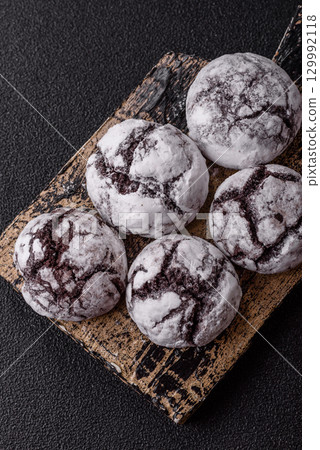 Chocolate crinkle cookies sprinkled with powdered sugar, homemade baking 129992118