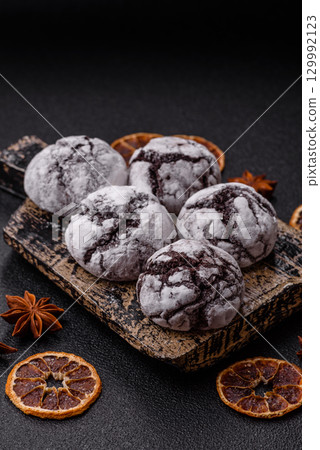 Chocolate crinkle cookies sprinkled with powdered sugar, homemade baking 129992123