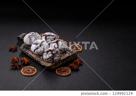 Chocolate crinkle cookies sprinkled with powdered sugar, homemade baking 129992124