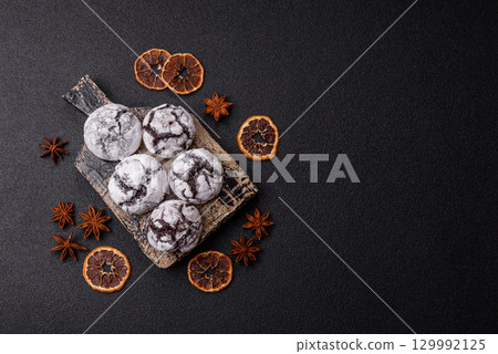 Chocolate crinkle cookies sprinkled with powdered sugar, homemade baking 129992125