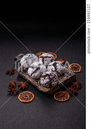 Chocolate crinkle cookies sprinkled with powdered sugar, homemade baking 129992127