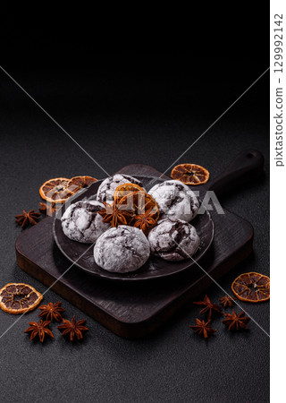 Chocolate crinkle cookies sprinkled with powdered sugar, homemade baking 129992142