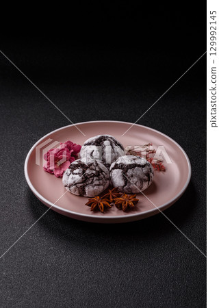 Chocolate crinkle cookies sprinkled with powdered sugar, homemade baking 129992145