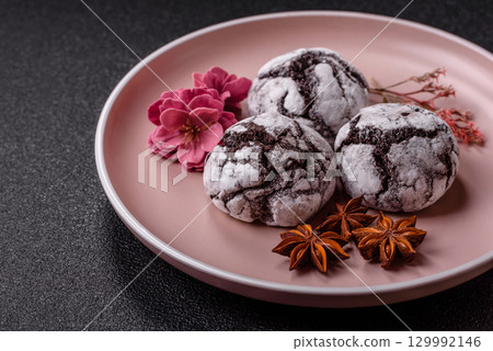 Chocolate crinkle cookies sprinkled with powdered sugar, homemade baking 129992146