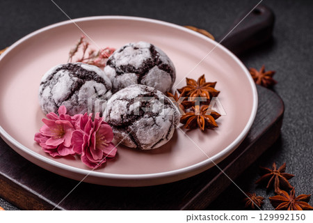 Chocolate crinkle cookies sprinkled with powdered sugar, homemade baking 129992150