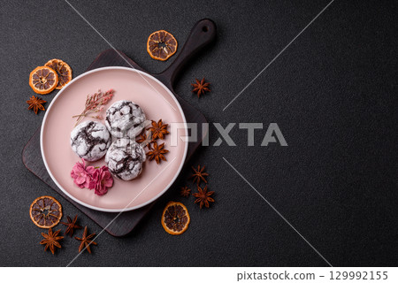Chocolate crinkle cookies sprinkled with powdered sugar, homemade baking 129992155