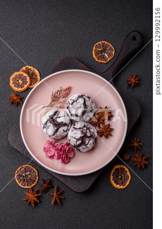 Chocolate crinkle cookies sprinkled with powdered sugar, homemade baking 129992156