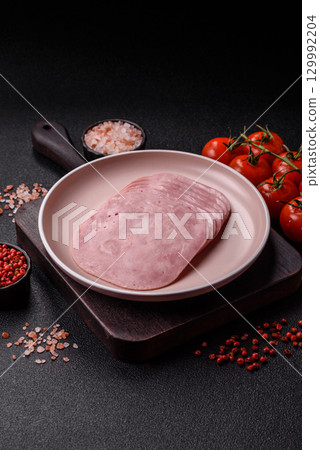 Sliced ham, meat or pork sausage for sandwiches. Cooked smoked prosciutto, ham Sliced ham, meat or pork sausage for sandwiches. Cooked smoked prosciutto, ham 129992204