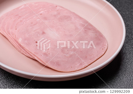 Sliced ham, meat or pork sausage for sandwiches. Cooked smoked prosciutto, ham Sliced ham, meat or pork sausage for sandwiches. Cooked smoked prosciutto, ham 129992209
