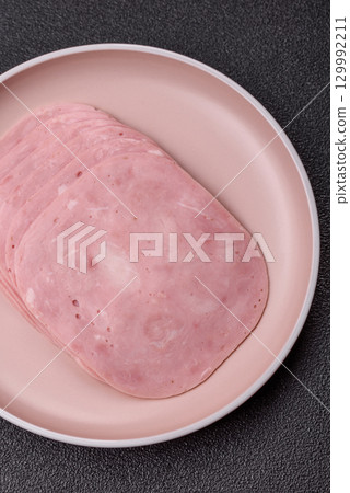Sliced ham, meat or pork sausage for sandwiches. Cooked smoked prosciutto, ham Sliced ham, meat or pork sausage for sandwiches. Cooked smoked prosciutto, ham 129992211