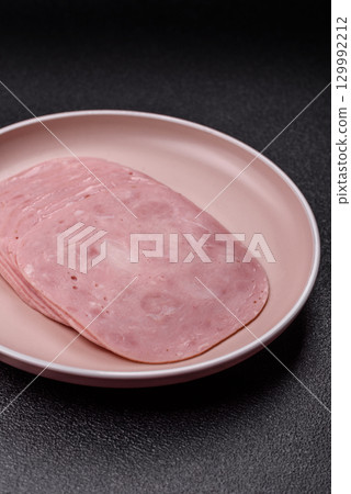Sliced ham, meat or pork sausage for sandwiches. Cooked smoked prosciutto, ham Sliced ham, meat or pork sausage for sandwiches. Cooked smoked prosciutto, ham 129992212