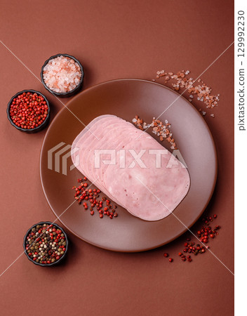 Sliced ham, meat or pork sausage for sandwiches. Cooked smoked prosciutto, ham Sliced ham, meat or pork sausage for sandwiches. Cooked smoked prosciutto, ham 129992230