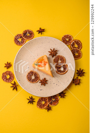 A slice of yellow cheesecake cake flavored with lemon and passion fruit A slice of yellow cheesecake cake flavored with lemon and passion fruit 129992244