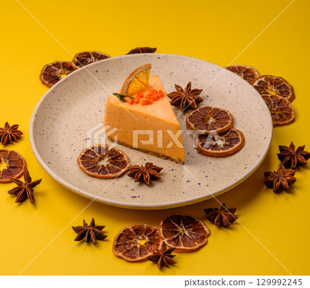 A slice of yellow cheesecake cake flavored with lemon and passion fruit A slice of yellow cheesecake cake flavored with lemon and passion fruit 129992245