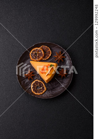 A slice of yellow cheesecake cake flavored with lemon and passion fruit A slice of yellow cheesecake cake flavored with lemon and passion fruit 129992248