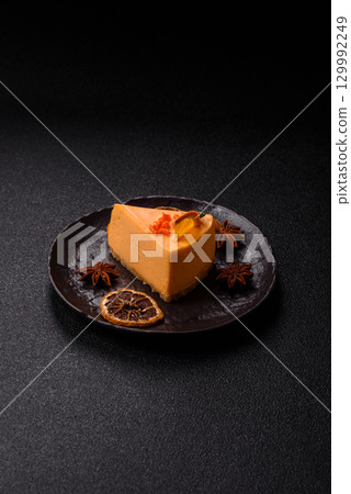 A slice of yellow cheesecake cake flavored with lemon and passion fruit 129992249