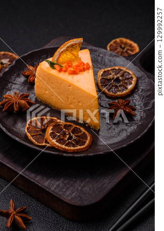 A slice of yellow cheesecake cake flavored with lemon and passion fruit A slice of yellow cheesecake cake flavored with lemon and passion fruit 129992257