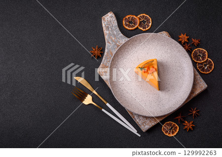 A slice of yellow cheesecake cake flavored with lemon and passion fruit A slice of yellow cheesecake cake flavored with lemon and passion fruit 129992263