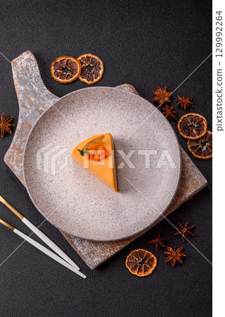 A slice of yellow cheesecake cake flavored with lemon and passion fruit A slice of yellow cheesecake cake flavored with lemon and passion fruit 129992264