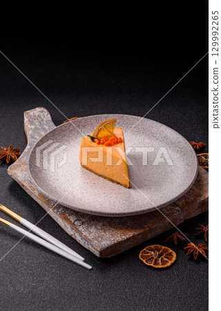 A slice of yellow cheesecake cake flavored with lemon and passion fruit 129992265