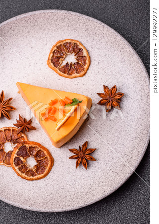 A slice of yellow cheesecake cake flavored with lemon and passion fruit 129992272