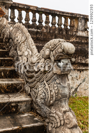 Intricately carved stone dragon sculpture on stair railing in Hue Imperial City Vietnam Intricately carved stone dragon sculpture on stair railing in Hue Imperial City Vietnam 129992393