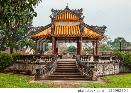 Traditional Vietnamese pavilion with tiled roof and carved dragon details in Hue Imperial City Traditional Vietnamese pavilion with tiled roof and carved dragon details in Hue Imperial City 129992394