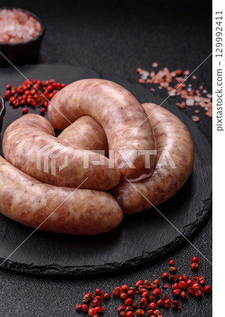 Raw meat sausages made from beef or pork, fresh meat for barbecuing or grilling. Raw sausages 129992411