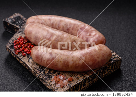 Raw meat sausages made from beef or pork, fresh meat for barbecuing or grilling. Raw sausages 129992424