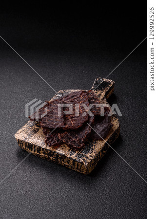 Snacks or jerky, beef slice meat dried, dehydrated. Beef snack Snacks or jerky, beef slice meat dried, dehydrated. Beef snack 129992526