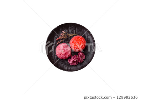 Chinese mooncake is an Asian sweet dessert. Asian mooncake as a background for your design Chinese mooncake is an Asian sweet dessert. Asian mooncake as a background for your design 129992636