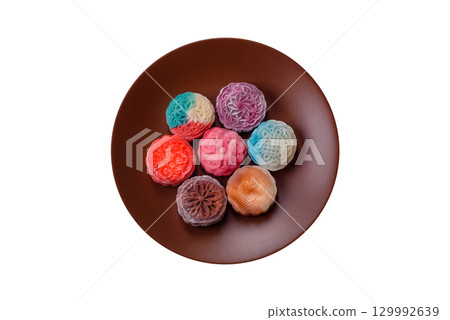 Chinese mooncake is an Asian sweet dessert. Asian mooncake as a background for your design 129992639