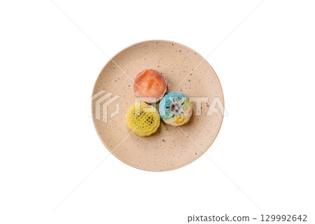 Chinese mooncake is an Asian sweet dessert. Asian mooncake as a background for your design 129992642