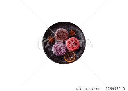 Chinese mooncake is an Asian sweet dessert. Asian mooncake as a background for your design 129992643