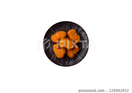 Chicken nuggets in breading, takeaway food, junk food Chicken nuggets in breading, takeaway food, junk food 129992652