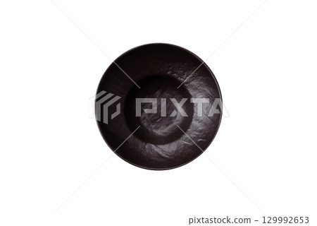 Empty round black plate for food, risotto or pasta. Empty plate on dark background Empty round black plate for food, risotto or pasta. Empty plate on dark background 129992653