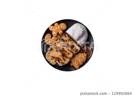 Christmas Stollen, a German sweet cake with marzipan and fruit. Winter Christmas Stollen 129992664