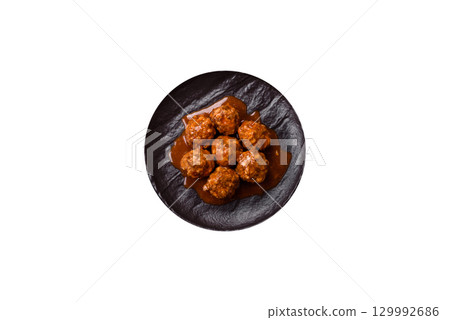 Meat, meatballs in tomato sauce, Italian food, beef or pork with salt . Meatballs with tomatoes Meat, meatballs in tomato sauce, Italian food, beef or pork with salt . Meatballs with tomatoes 129992686