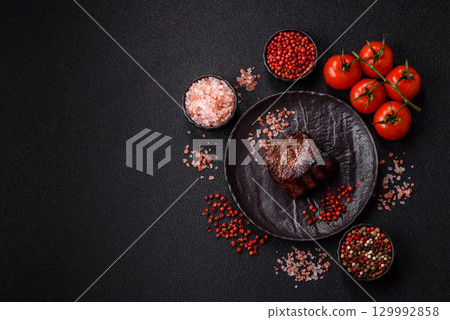 Grilled beef steak meat with salt and pepper. Beef steak grilled on a barbecue Grilled beef steak meat with salt and pepper. Beef steak grilled on a barbecue 129992858