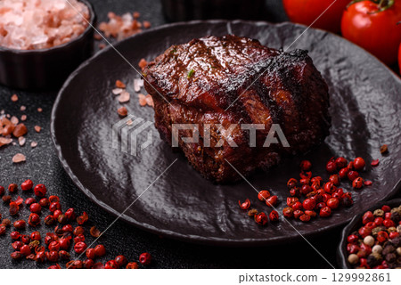 Grilled beef steak meat with salt and pepper. Beef steak grilled on a barbecue Grilled beef steak meat with salt and pepper. Beef steak grilled on a barbecue 129992861