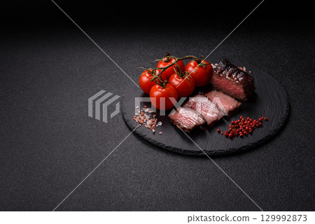 Grilled beef steak meat with salt and pepper. Beef steak grilled on a barbecue 129992873