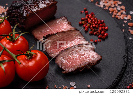 Grilled beef steak meat with salt and pepper. Beef steak grilled on a barbecue Grilled beef steak meat with salt and pepper. Beef steak grilled on a barbecue 129992881