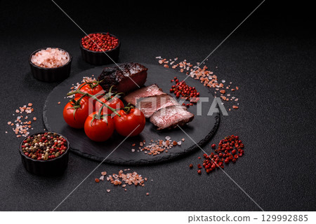 Grilled beef steak meat with salt and pepper. Beef steak grilled on a barbecue Grilled beef steak meat with salt and pepper. Beef steak grilled on a barbecue 129992885