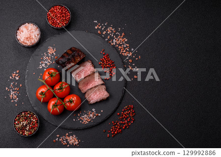 Grilled beef steak meat with salt and pepper. Beef steak grilled on a barbecue Grilled beef steak meat with salt and pepper. Beef steak grilled on a barbecue 129992886